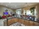 Open kitchen has granite countertops, breakfast bar and seamless transition into the living area at 16112 W Whitton Ave, Goodyear, AZ 85395