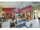 Spacious living room showcases an open concept design with vibrant red accent wall and tile floors at 16112 W Whitton Ave, Goodyear, AZ 85395