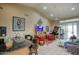 Open-concept living area with bar, tile floors, and ample seating at 16112 W Whitton Ave, Goodyear, AZ 85395