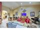 Expansive living area with bar, high ceilings, and tiled floors at 16112 W Whitton Ave, Goodyear, AZ 85395