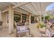 Spacious covered patio area with various seating arrangements, ideal for relaxation and social gatherings at 16112 W Whitton Ave, Goodyear, AZ 85395