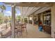 Expansive covered patio with multiple seating areas, offering a perfect space for outdoor entertaining at 16112 W Whitton Ave, Goodyear, AZ 85395