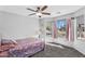 Bright bedroom with a ceiling fan, a large window, and gray carpet at 17152 W Watkins St, Goodyear, AZ 85338