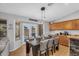 Dining room with modern light fixture, wood floors, and access to the backyard at 17152 W Watkins St, Goodyear, AZ 85338