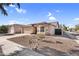 Inviting home exterior with desert landscaping, a two-car garage, and a charming, covered front entry at 17152 W Watkins St, Goodyear, AZ 85338