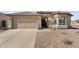 Charming home exterior with a two-car garage, desert landscaping, and welcoming covered entry at 17152 W Watkins St, Goodyear, AZ 85338
