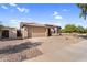 Single-story home featuring a two-car garage, desert landscaping and concrete driveway at 17152 W Watkins St, Goodyear, AZ 85338