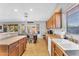 Functional kitchen with wood cabinets, stainless steel sink, and adjacent dining area at 17152 W Watkins St, Goodyear, AZ 85338