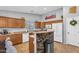 Bright kitchen with wood cabinets, white appliances, and breakfast bar at 17152 W Watkins St, Goodyear, AZ 85338