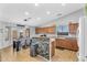 Stylish kitchen with wood cabinets, an island with stone accent, and adjacent dining area at 17152 W Watkins St, Goodyear, AZ 85338