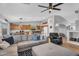 Open-concept living room with a comfortable sectional sofa, ceiling fan, and seamless flow to the kitchen at 17152 W Watkins St, Goodyear, AZ 85338
