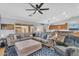Spacious living room with a large sectional, open layout, and ceiling fan, perfect for gatherings and relaxation at 17152 W Watkins St, Goodyear, AZ 85338