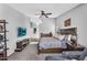 Comfortable main bedroom with carpet flooring, ceiling fan, dresser, and sitting area at 17152 W Watkins St, Goodyear, AZ 85338