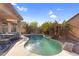 Backyard pool surrounded by desert landscaping and a covered patio with seating at 17152 W Watkins St, Goodyear, AZ 85338