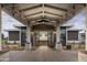 Covered entrance with exposed beams leading to a modern building; 'Locker Rooms' sign visible at 17160 W Montpelier St, Surprise, AZ 85388