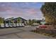Rows of golf carts parked near a modern clubhouse with beautiful evening sky at 17160 W Montpelier St, Surprise, AZ 85388