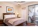 Cozy bedroom features a sliding glass door leading to a private balcony, allowing for natural light at 18416 N Cave Creek Rd # 3050, Phoenix, AZ 85032
