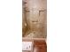 A tiled shower is equipped with both rainfall and handheld shower heads, plus safety grab bars at 18416 N Cave Creek Rd # 3050, Phoenix, AZ 85032