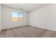 Cozy bedroom with neutral carpeting and a bright window at 18498 E Dario Rd, Gold Canyon, AZ 85118