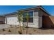 Attractive home with a two-car garage, beautiful front landscaping, rock features, and desert-style plantings at 18498 E Dario Rd, Gold Canyon, AZ 85118