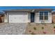 Charming home with a well-maintained front yard, a gray-brick driveway, and a two-car garage at 18498 E Dario Rd, Gold Canyon, AZ 85118