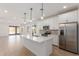 Open kitchen boasts an island, stainless appliances, and sleek white cabinets at 18498 E Dario Rd, Gold Canyon, AZ 85118