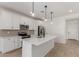 Bright kitchen features an island, stainless appliances, and modern pendant lights at 18498 E Dario Rd, Gold Canyon, AZ 85118