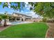 Large backyard with a pool, patio, and expansive green lawn at 19203 N 39Th Way, Phoenix, AZ 85050