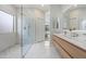 Modern bathroom with marble floors, glass shower, and light wood vanity at 19203 N 39Th Way, Phoenix, AZ 85050