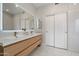 Contemporary bathroom featuring a double sink vanity and sliding closet doors at 19203 N 39Th Way, Phoenix, AZ 85050