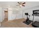 Open bonus room featuring a ceiling fan, neutral walls, and an exercise bike and treadmill at 19203 N 39Th Way, Phoenix, AZ 85050