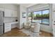 Breakfast nook with backyard pool views, built in desk and cabinet space, and stainless steel fridge at 19203 N 39Th Way, Phoenix, AZ 85050