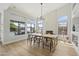 Dining area has large windows, fireplace, built in wine storage, and backyard views and patio access at 19203 N 39Th Way, Phoenix, AZ 85050
