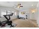 Bright exercise room with a Peloton bike, mirror, and ceiling fan at 19203 N 39Th Way, Phoenix, AZ 85050