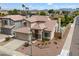 Front exterior of a two story home with desert landscaping and three car garage at 19203 N 39Th Way, Phoenix, AZ 85050