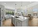 The kitchen has quartz counters, stainless steel appliances, and a view of the dining area and backyard at 19203 N 39Th Way, Phoenix, AZ 85050