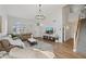 Bright living room boasts wood floors, white walls, lots of natural light, and a modern chandelier at 19203 N 39Th Way, Phoenix, AZ 85050