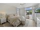 Bright main bedroom has wood floors, white walls, a ceiling fan, backyard views, and a TV at 19203 N 39Th Way, Phoenix, AZ 85050
