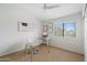 Bright office with a glass desk, diplomas, and a window providing natural light at 19203 N 39Th Way, Phoenix, AZ 85050