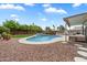 Backyard with a beautiful blue pool, rock landscaping, seating and a covered patio at 19203 N 39Th Way, Phoenix, AZ 85050