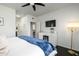Cozy main bedroom with hardwood floors, a TV, and ample closet space at 19777 N 76Th St # 3229, Scottsdale, AZ 85255