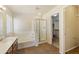 Bathroom showcasing a bathtub and shower, vanity and a door leading into a walk-in closet at 206 N 152Nd Ave, Goodyear, AZ 85338