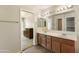 Large mirror above a double sink vanity, and a doorway looking into the main bedroom at 206 N 152Nd Ave, Goodyear, AZ 85338