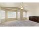 Spacious bedroom with large windows for lots of natural light and an overhead ceiling fan at 206 N 152Nd Ave, Goodyear, AZ 85338
