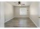 Bright bedroom with light-colored wood-look tile flooring and a window at 206 N 152Nd Ave, Goodyear, AZ 85338