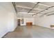 Spacious garage with white walls and grey floors, and shelving along the back wall at 206 N 152Nd Ave, Goodyear, AZ 85338