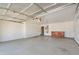 Spacious garage with white walls and grey floors, also showing shelving and water heater at 206 N 152Nd Ave, Goodyear, AZ 85338