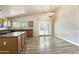 Open kitchen and dining area with wood-look tile floors and backyard access at 206 N 152Nd Ave, Goodyear, AZ 85338