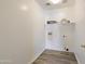Simple laundry room with white walls and shelving to provide storage at 206 N 152Nd Ave, Goodyear, AZ 85338