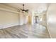 Open-concept living area featuring wood-look floors and access to other rooms at 206 N 152Nd Ave, Goodyear, AZ 85338